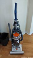 Full view of Kenmore upright vacuum cleaner with hose attached and crevice tool mounted on side