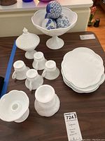 Full view of lot including covered compote, small pitchers, plates, candle holder, pedestal bowl, and ceramic balls in bowl.
