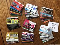 Overview of multiple stacks of TTC Metropass cards showing colorful designs and monthly passes from 2011 to 2014