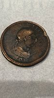 Obverse view of the 1806 United Kingdom 1 penny coin showing a right-facing monarch and the date 1806.