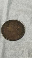 Obverse side of 1860 UK penny coin showing Queen Victoria profile and text with visible wear.
