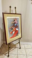 Framed lithograph print displayed on an easel, showing the full artwork and frame.