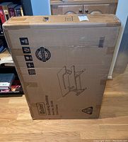 Photo of unopened Halter Elevating Desktop box showing front side with brand name and product drawing.