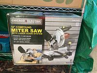Box front showing Chicago Electric Power Tools 10" Compound Miter Saw with Laser Guide System