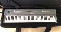 Front view of grey Studiologic SL-990 XP keyboard inside soft case showing full 88-key layout