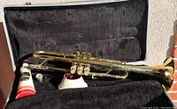 Bundy designed by Vincent Bach trumpet inside the plush-lined hard case along with mouthpiece, valve oil, and cleaning tools.