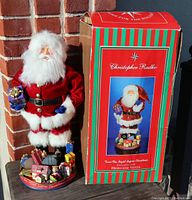 Full view of Christopher Radko Twas the Night Before Christmas Heirloom Santa figurine next to original box
