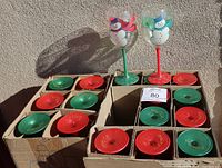 18 large hand painted Christmas snowman wine glasses arranged in original box with red and green stems and bases.