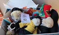 Three plush bears in box and showing papers with lot number