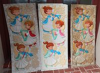 Three tall rectangular vintage blow mold angel carolers panels shown side-by-side, each featuring three angels with golden wings playing instruments and surrounded by raised snowflakes, in white, blue, pink, red and gold colors. Slight wear visible on two panels; middle panel clean and vibrant.