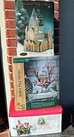 Original boxed items stacked: Heartland Valley Village Cathedral on top, Dept 56 Oakwood Post Office in the middle, Dept 56 Santa's Visiting Center at the bottom.