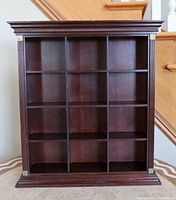 Full front view of the wood cabinet showing 12 square compartments.