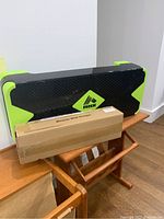 RBX exercise step and boxed bicycle wall hanger placed on a wooden chair.