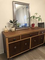 Front view of hutch with mirror and plants on top (mirror and plants not included)