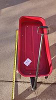 Top view of red Radio Flyer wagon with measuring tape along the side indicating 32 inch length of interior