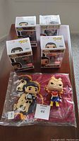 Six boxed Funko Pop figures from Marvel and Star Wars with a new Shang Chi t-shirt sealed in plastic in front