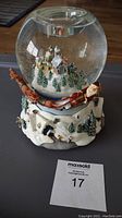 Front view of the Olde World Village tealight globe showing glass dome with miniature winter village scene and spinning Santa on the base.