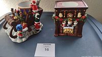 Two holiday-themed tea light aroma melts, including a fireplace design and a snowman duo on snow base