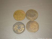 Four vintage brothel casino tokens showing text and images