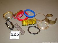 Full lot showing all bangles and bracelets arranged on a flat surface