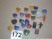 Overview of 22 Millefiori style glass charms including heart shapes, crosses, and rectangular pendants.