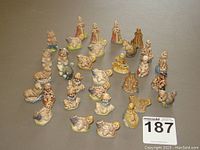 Overview of all Red Rose Tea Wade figurines arranged spaced on flat surface showing various nursery rhyme characters and animals.