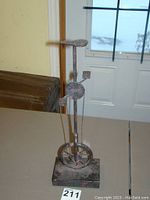 Front and angled view of the iron unicycle statue showing full height and details