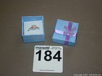 Closed box with ring inside displayed and auction lot number card