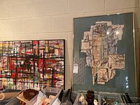 Both framed artworks displayed side by side showing their size comparison and condition.