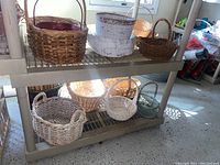 Wicker baskets in natural and whitewashed finishes on two shelves.