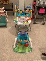 Photo showing three children's play seats in a room on a carpeted floor.