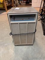 Front view of Westinghouse dehumidifier showing control knob, vented front panel, and signs of scratches and dust.