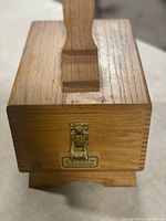 Closed wooden box with brass latch and Griffin Shinemaster label on the front