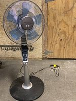 Full view of Rowenta Turbo Silence fan with metal blades and round base standing on floor.