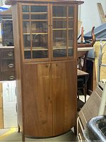 Front view of the Danish style wood cabinet showing glass doors on top and wooden doors below.