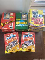 Top view showing unopened boxes and packs in original packaging including Donruss Pop-Up Puzzle & Cards (1988), Pacific Baseball Legends series, 1991 Score MLB Baseball Box, and 1989 Baseball Greats Boxes.