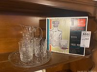 Boxed Bormioli-Rocco Selecta 7-piece whiskey decanter set displayed next to pitcher, glasses and tray.