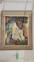 Full view of framed painting hung on wall, showing composition and overall condition