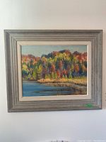 Full view of the framed oil painting showing the landscape scene and frame details.