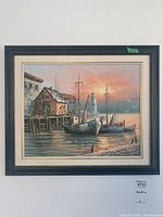 Full view of the framed painting showing the harbor scene with boats, dock, lighthouse, and sunset.