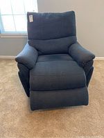 Front view of the electric blue recliner chair showing extended footrest and padded cushions.