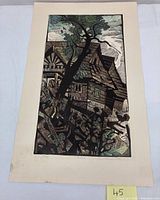 Full view of the linocut art print showing an abstract countryside home with a large tree in front, with strong textures and limited color palette.