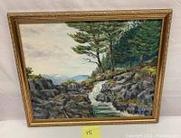 Full view of the oil on canvas landscape painting showing a mountain stream, trees, and surrounding rocky terrain with a gold frame.