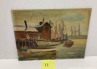 Full view of oil on board painting depicting harbor boats and boathouse with muted color palette and calm water.