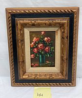 Framed oil painting of a still life bouquet of roses in a green vase, showing the entire artwork and frame.