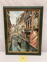 Front view of the framed oil on canvas painting featuring a Venetian canal, gondola, and buildings.