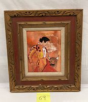 Front view of framed oil painting showing bullfighter and bull