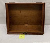 Top-down view of interior showing wooden bottom and back panel with some surface stains and wear.