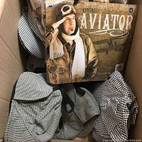 Photo of character hats in box including black and white checkered Sherlock deerstalker and vintage aviator hat kit box