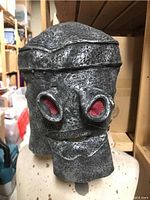 Front view of metallic black/silver Robot Chicken mask on mannequin head